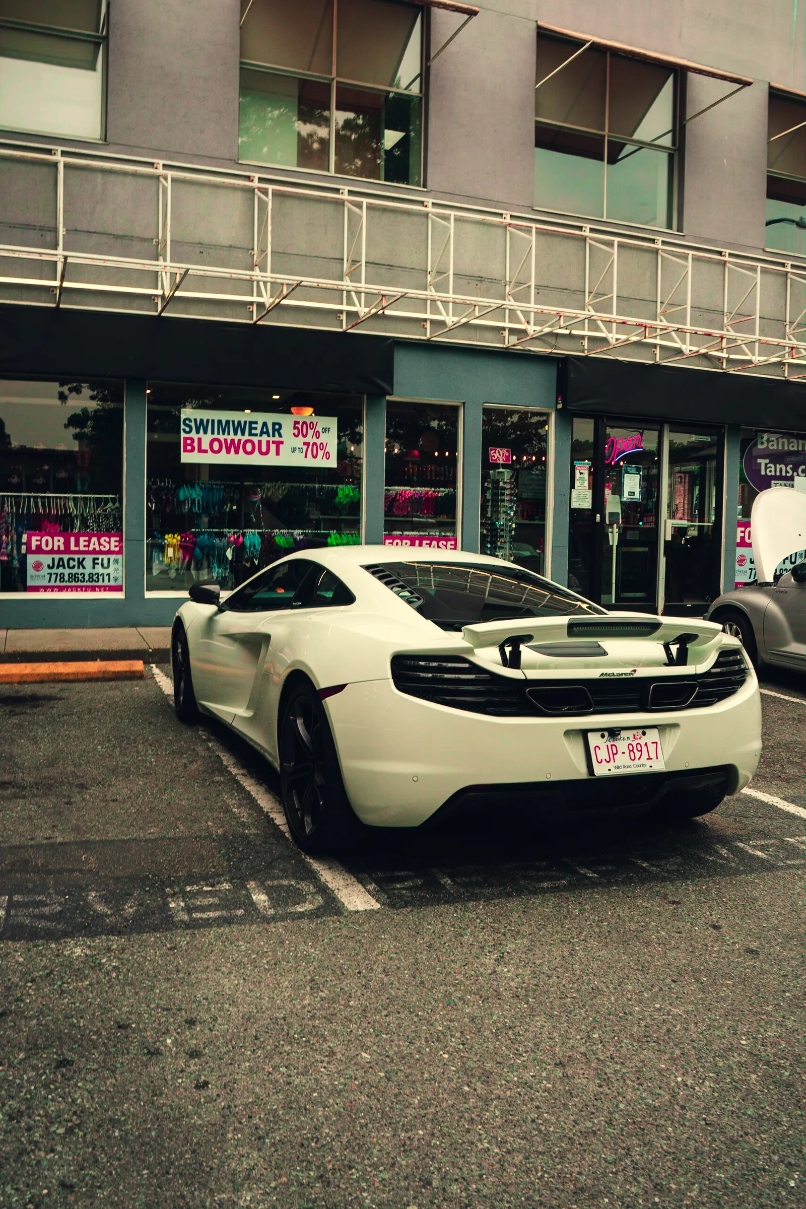White sports car parked on a city street